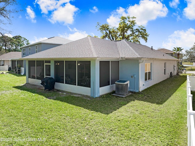 1652 La Maderia Dr, Palm Bay, FL 32908 - rear view of property featuring a sunroom, a lawn, a shingled roof, and stucco siding
