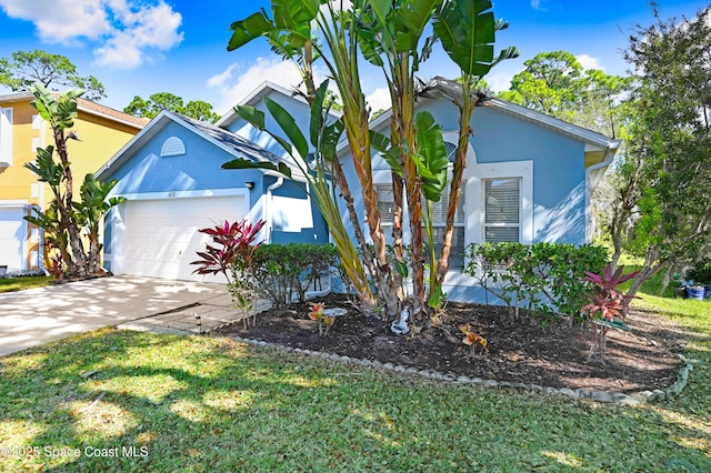 1652 La Maderia Dr, Palm Bay, FL 32908 - view of front of house featuring stucco siding, an attached garage, driveway, and a front lawn