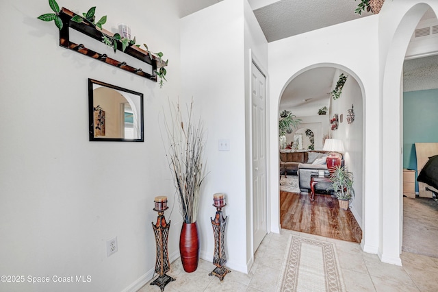 1652 La Maderia Dr, Palm Bay, FL 32908 - hall featuring light tile patterned floors and arched walkways