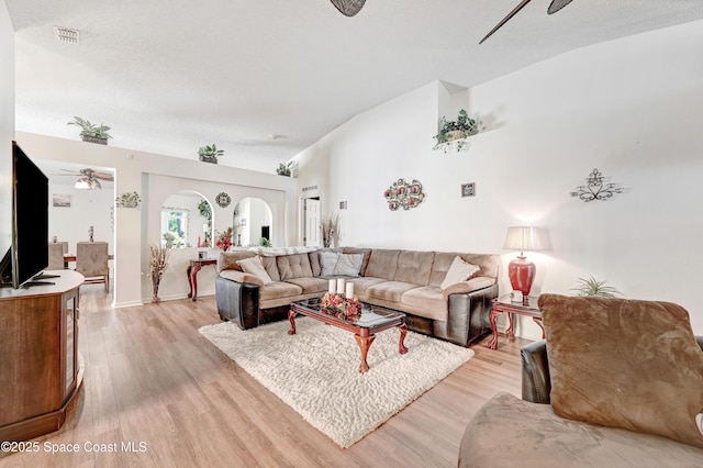 1652 La Maderia Dr, Palm Bay, FL 32908 - living area with ceiling fan, light wood finished floors, lofted ceiling, and arched walkways