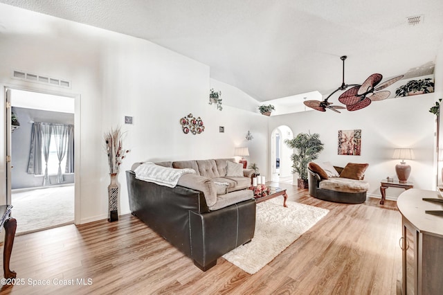 1652 La Maderia Dr, Palm Bay, FL 32908 - living room featuring arched walkways, ceiling fan, light wood-style floors, and lofted ceiling