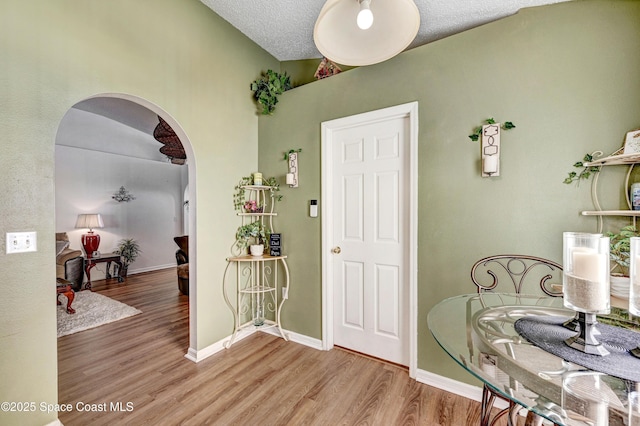 1652 La Maderia Dr, Palm Bay, FL 32908 - entryway featuring arched walkways, wood finished floors, and a textured ceiling