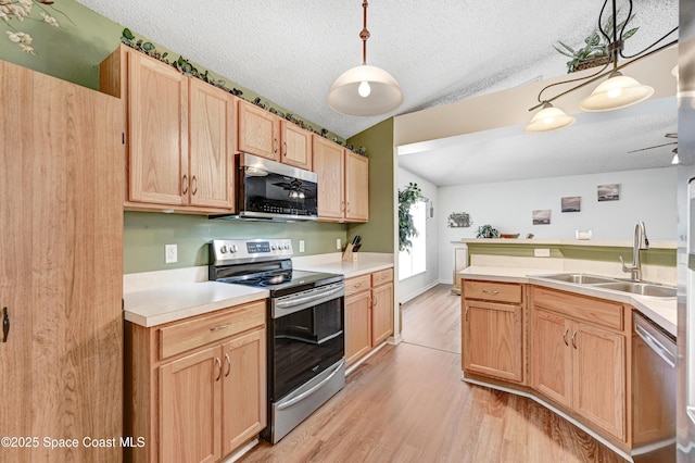 1652 La Maderia Dr, Palm Bay, FL 32908 - kitchen featuring stainless steel appliances, light wood-style flooring, light countertops, light brown cabinetry, and a textured ceiling