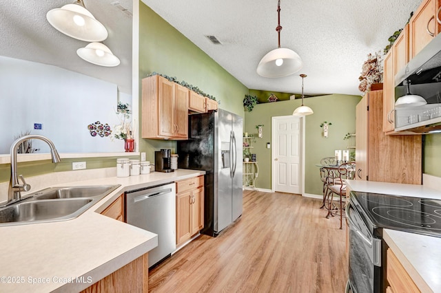 1652 La Maderia Dr, Palm Bay, FL 32908 - kitchen featuring stainless steel appliances, light wood finished floors, a textured ceiling, light countertops, and decorative light fixtures