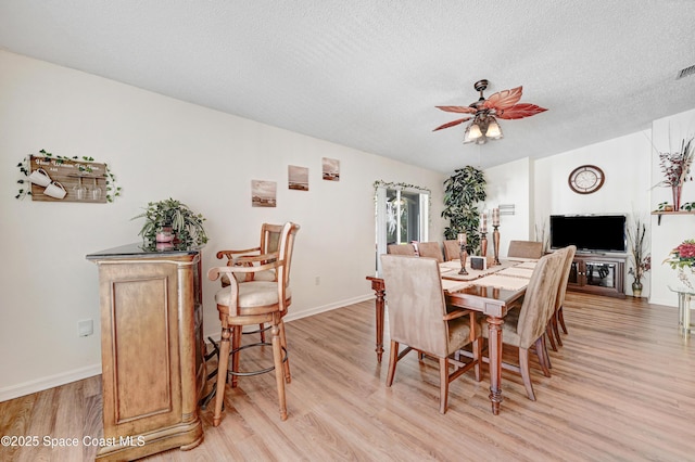 1652 La Maderia Dr, Palm Bay, FL 32908 - dining room featuring light wood-type flooring, a ceiling fan, and a textured ceiling