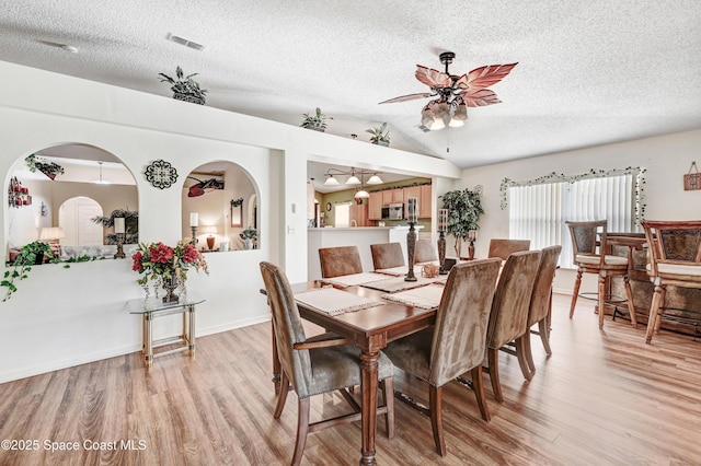 1652 La Maderia Dr, Palm Bay, FL 32908 - dining room featuring light wood finished floors, a textured ceiling, and ceiling fan