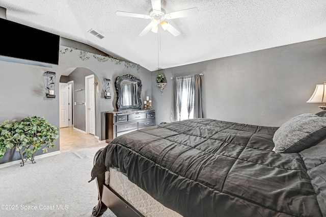 1652 La Maderia Dr, Palm Bay, FL 32908 - bedroom with a textured ceiling, arched walkways, vaulted ceiling, light colored carpet, and ceiling fan