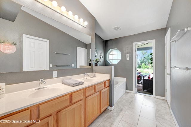 1652 La Maderia Dr, Palm Bay, FL 32908 - full bath with double vanity, a garden tub, and tile patterned floors