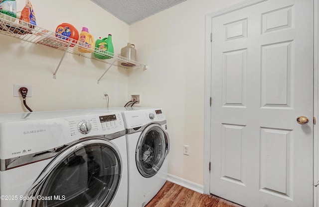 1652 La Maderia Dr, Palm Bay, FL 32908 - laundry room featuring washing machine and dryer, light wood finished floors, and a textured ceiling