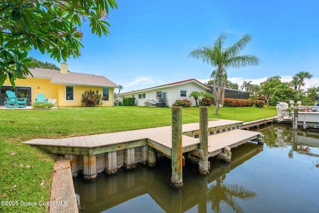 33 Yawl Dr, Cocoa Beach, FL 32931 - dock featuring a lawn and a water view