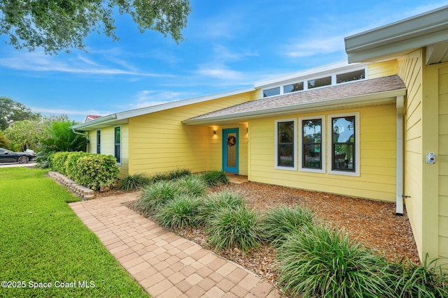 33 Yawl Dr, Cocoa Beach, FL 32931 - view of front of property with a front lawn