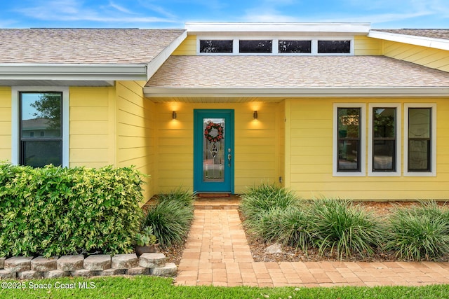 33 Yawl Dr, Cocoa Beach, FL 32931 - doorway to property with a shingled roof