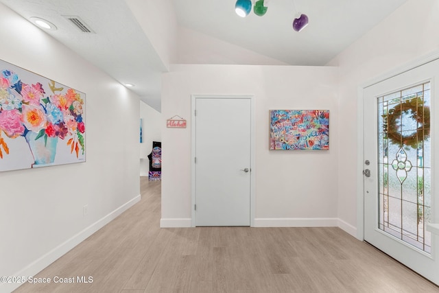 33 Yawl Dr, Cocoa Beach, FL 32931 - entryway featuring light wood-style flooring and lofted ceiling