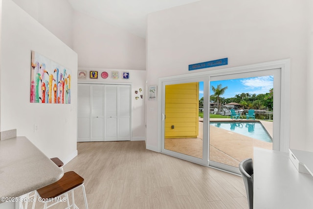 33 Yawl Dr, Cocoa Beach, FL 32931 - doorway featuring high vaulted ceiling and wood finished floors