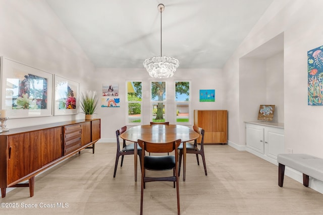 33 Yawl Dr, Cocoa Beach, FL 32931 - dining area featuring lofted ceiling, a chandelier, and light wood-type flooring