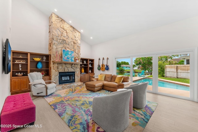 33 Yawl Dr, Cocoa Beach, FL 32931 - living room with high vaulted ceiling, wood finished floors, a fireplace, and recessed lighting