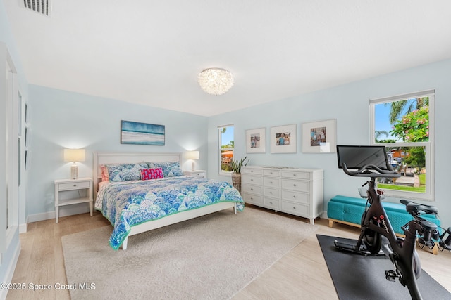 33 Yawl Dr, Cocoa Beach, FL 32931 - bedroom featuring multiple windows and wood finished floors