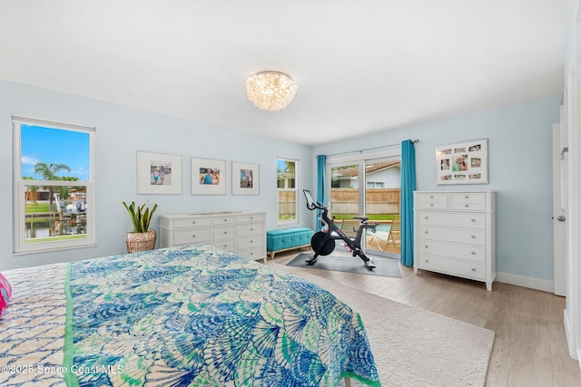 33 Yawl Dr, Cocoa Beach, FL 32931 - bedroom with light wood finished floors and a chandelier