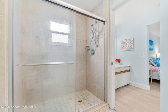 33 Yawl Dr, Cocoa Beach, FL 32931 - ensuite bathroom with a stall shower, vanity, and wood finished floors
