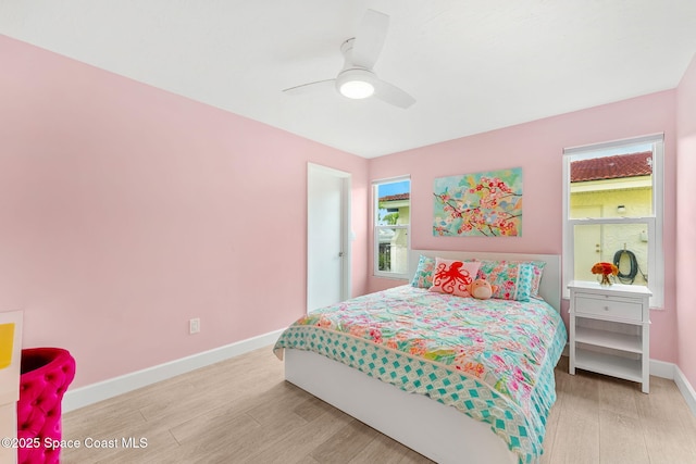 33 Yawl Dr, Cocoa Beach, FL 32931 - bedroom featuring light wood finished floors and ceiling fan