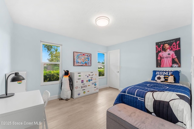33 Yawl Dr, Cocoa Beach, FL 32931 - bedroom featuring baseboards and light wood-style flooring