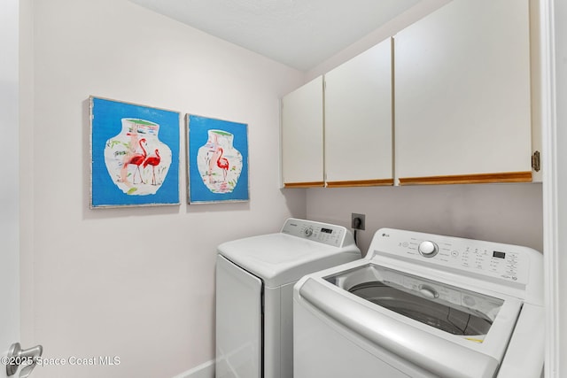33 Yawl Dr, Cocoa Beach, FL 32931 - laundry area featuring cabinet space and separate washer and dryer