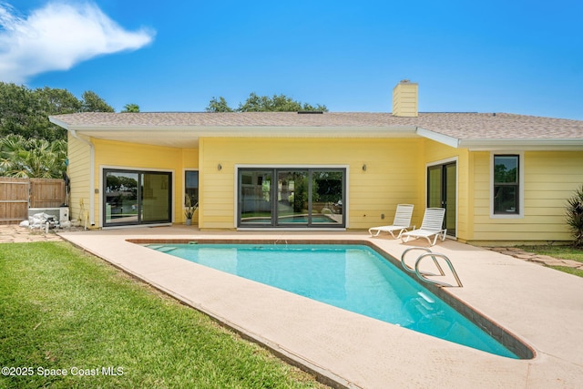 33 Yawl Dr, Cocoa Beach, FL 32931 - back of property with a patio, a chimney, and an outdoor pool