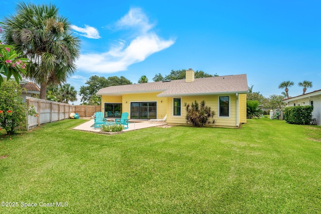 33 Yawl Dr, Cocoa Beach, FL 32931 - back of property featuring a patio, a chimney, and a fenced backyard