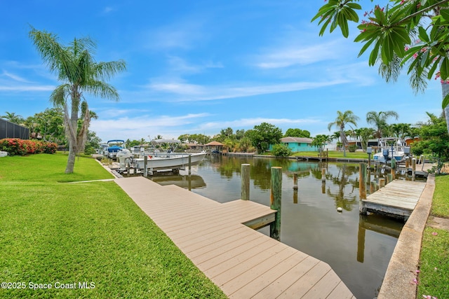 33 Yawl Dr, Cocoa Beach, FL 32931 - dock featuring a water view, a lawn, and boat lift