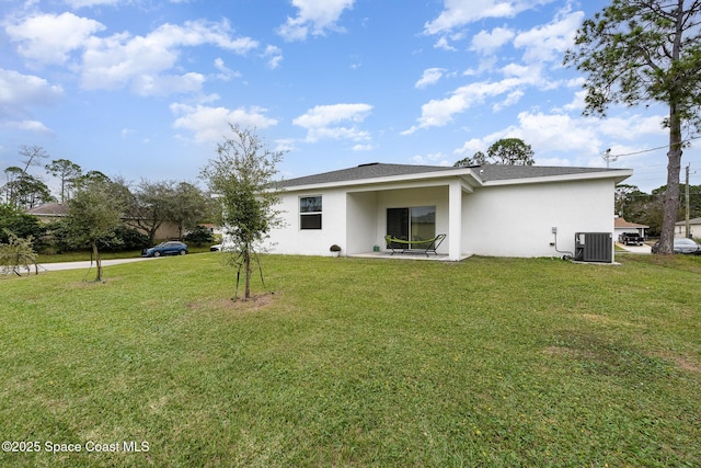 1441 Waco Blvd SE, Palm Bay, FL 32909 - back of house with stucco siding and a yard