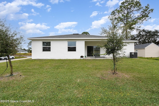 1441 Waco Blvd SE, Palm Bay, FL 32909 - rear view of property with stucco siding and a lawn