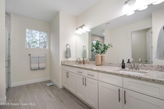 1441 Waco Blvd SE, Palm Bay, FL 32909 - bathroom with double vanity, wood finished floors, and a shower stall