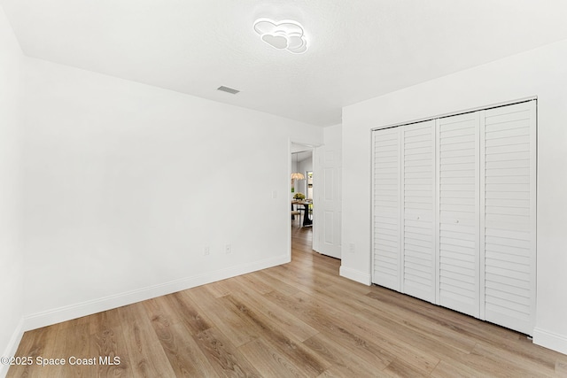 494 Fernandina St NW, Palm Bay, FL 32907 - unfurnished bedroom with light wood-type flooring and a closet
