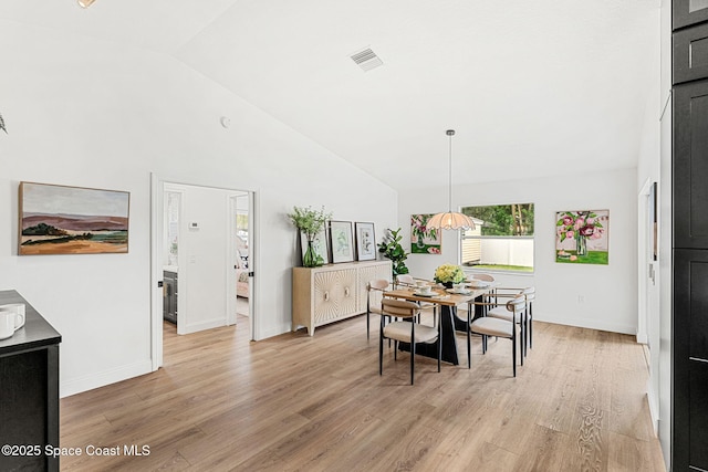 494 Fernandina St NW, Palm Bay, FL 32907 - dining room with light wood-style floors and high vaulted ceiling