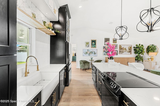 494 Fernandina St NW, Palm Bay, FL 32907 - kitchen featuring black appliances, a chandelier, dark cabinets, light wood-style flooring, and decorative light fixtures