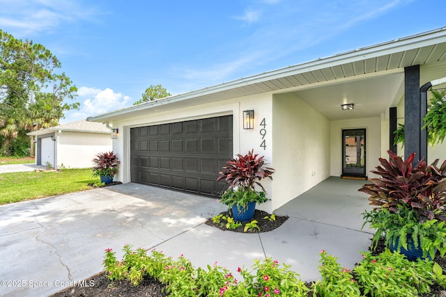 494 Fernandina St NW, Palm Bay, FL 32907 - view of front facade featuring stucco siding, an attached garage, and driveway