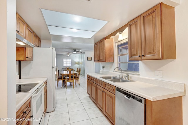1216 Cannon St, Melbourne, FL 32935 - kitchen with stainless steel dishwasher, electric range, a ceiling fan, under cabinet range hood, and light tile patterned flooring