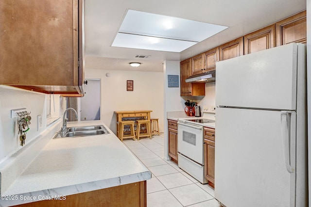 1216 Cannon St, Melbourne, FL 32935 - kitchen featuring white appliances, light tile patterned flooring, light countertops, and under cabinet range hood