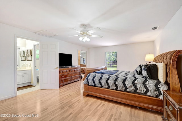 1216 Cannon St, Melbourne, FL 32935 - bedroom with light wood-style floors, ensuite bathroom, a ceiling fan, and attic access