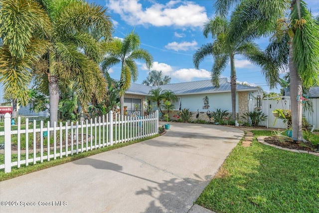 2975 Matthew Dr, Rockledge, FL 32955 - view of front of home featuring driveway, stucco siding, and a fenced front yard