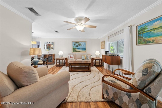 2975 Matthew Dr, Rockledge, FL 32955 - living room with wood finished floors, ornamental molding, and a ceiling fan