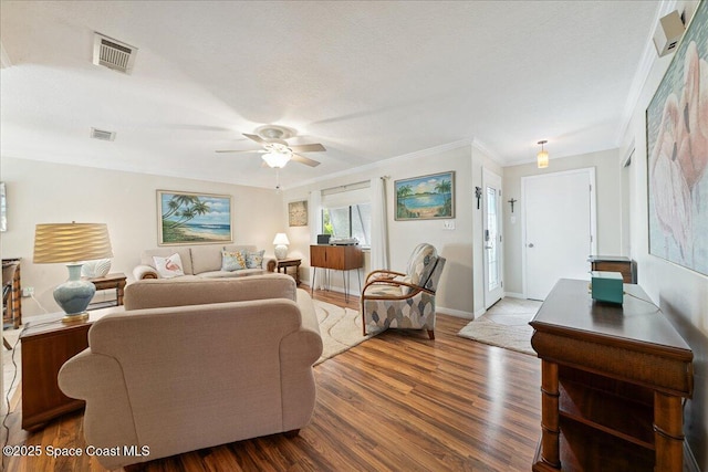 2975 Matthew Dr, Rockledge, FL 32955 - living room featuring a ceiling fan, wood finished floors, and ornamental molding
