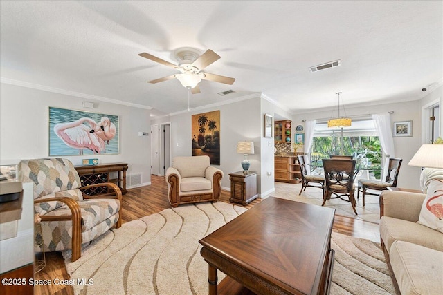 2975 Matthew Dr, Rockledge, FL 32955 - living room featuring light wood-style flooring, crown molding, and ceiling fan
