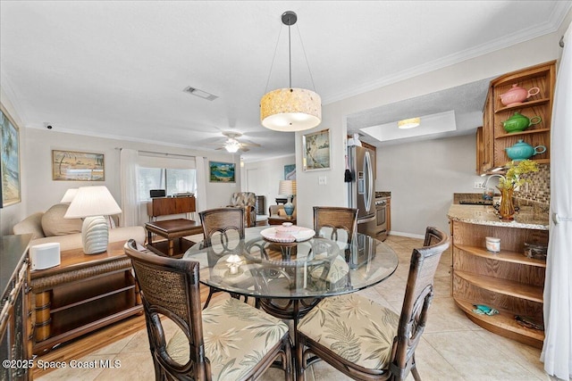 2975 Matthew Dr, Rockledge, FL 32955 - dining room featuring light tile patterned floors, crown molding, and a ceiling fan
