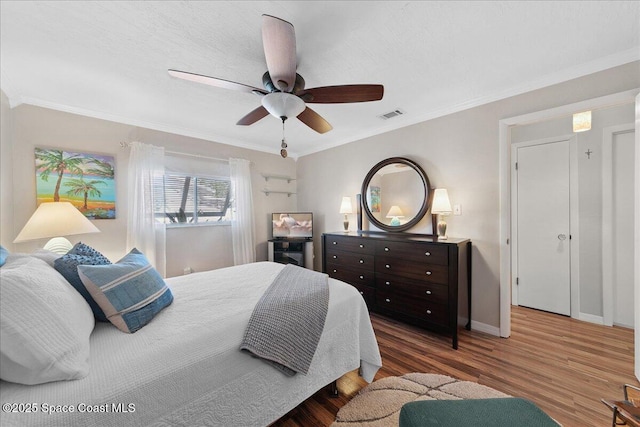 2975 Matthew Dr, Rockledge, FL 32955 - bedroom featuring wood finished floors, ornamental molding, and ceiling fan