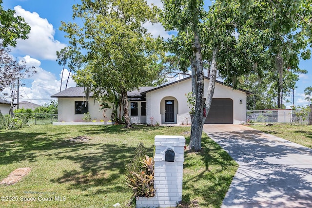 1384 Vancouver Ave SE, Palm Bay, FL 32909 - view of front of home with a garage, driveway, and stucco siding