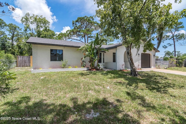 1384 Vancouver Ave SE, Palm Bay, FL 32909 - view of front facade featuring a garage, brick siding, and driveway