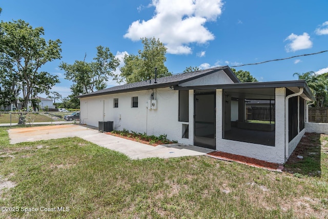 1384 Vancouver Ave SE, Palm Bay, FL 32909 - rear view of house featuring stucco siding and a sunroom