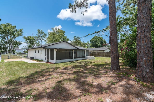 1384 Vancouver Ave SE, Palm Bay, FL 32909 - back of house featuring a sunroom