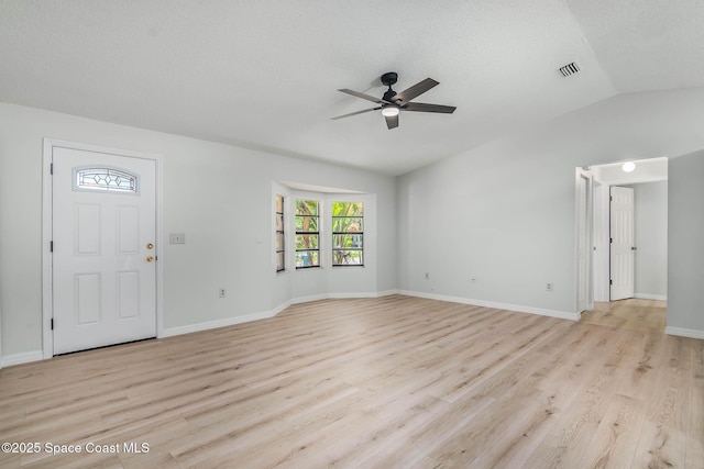 1384 Vancouver Ave SE, Palm Bay, FL 32909 - foyer entrance with a ceiling fan, lofted ceiling, light wood finished floors, and a textured ceiling